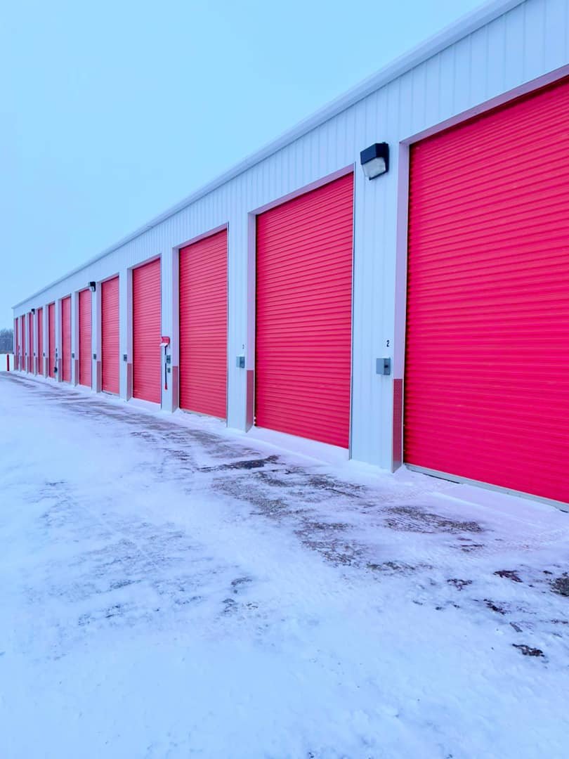Secure outdoor storage units with paved lanes at Maxim Storage Grande Prairie